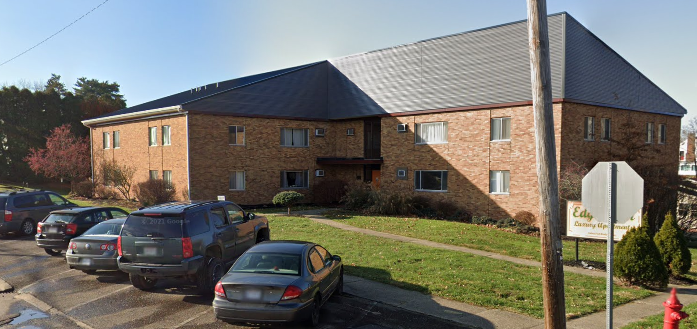 a large brick building with cars parked in front of it