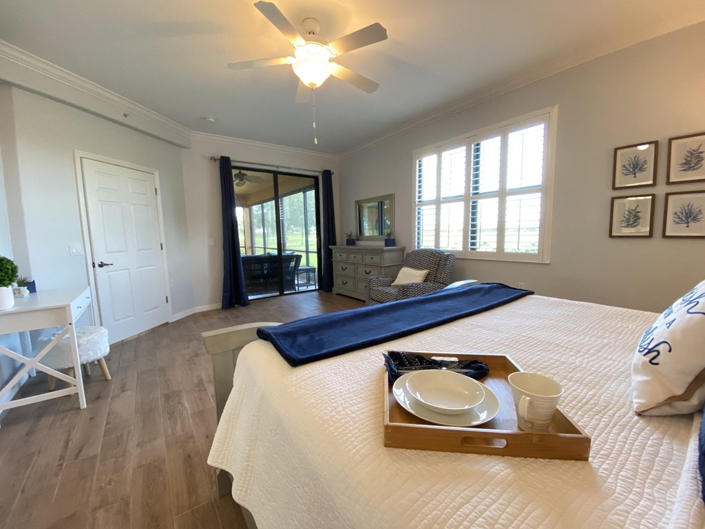 a master bedroom with a large bed and a ceiling fan