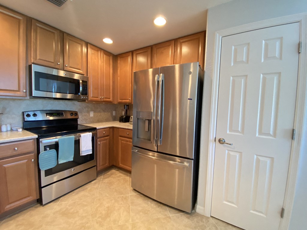 a kitchen with stainless steel appliances and wooden cabinets