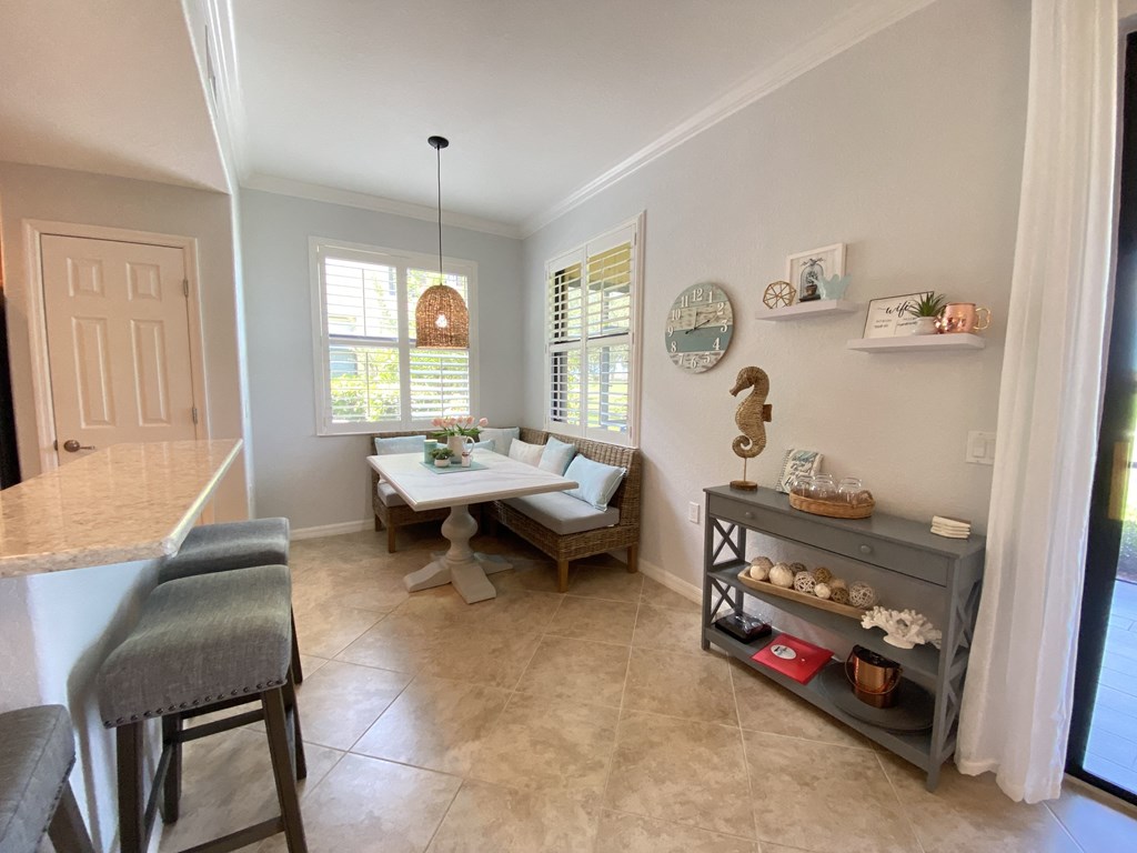 a dining room with a table and chairs and a window