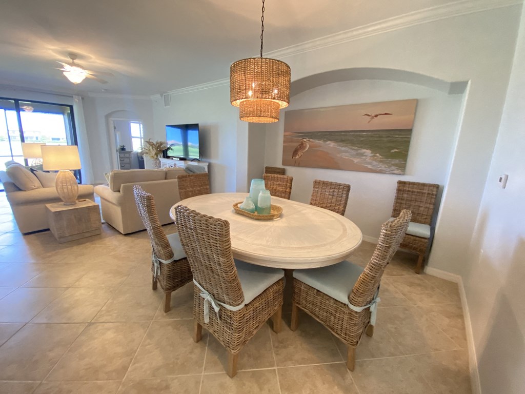 a dining room with a table and chairs and a chandelier