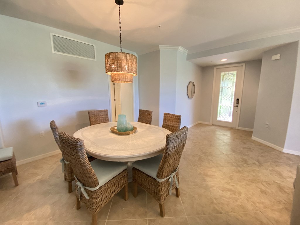 a dining room with a table and chairs and a chandelier