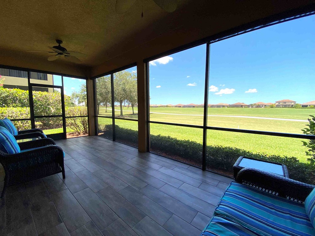 a large screened porch with a view of a soccer field