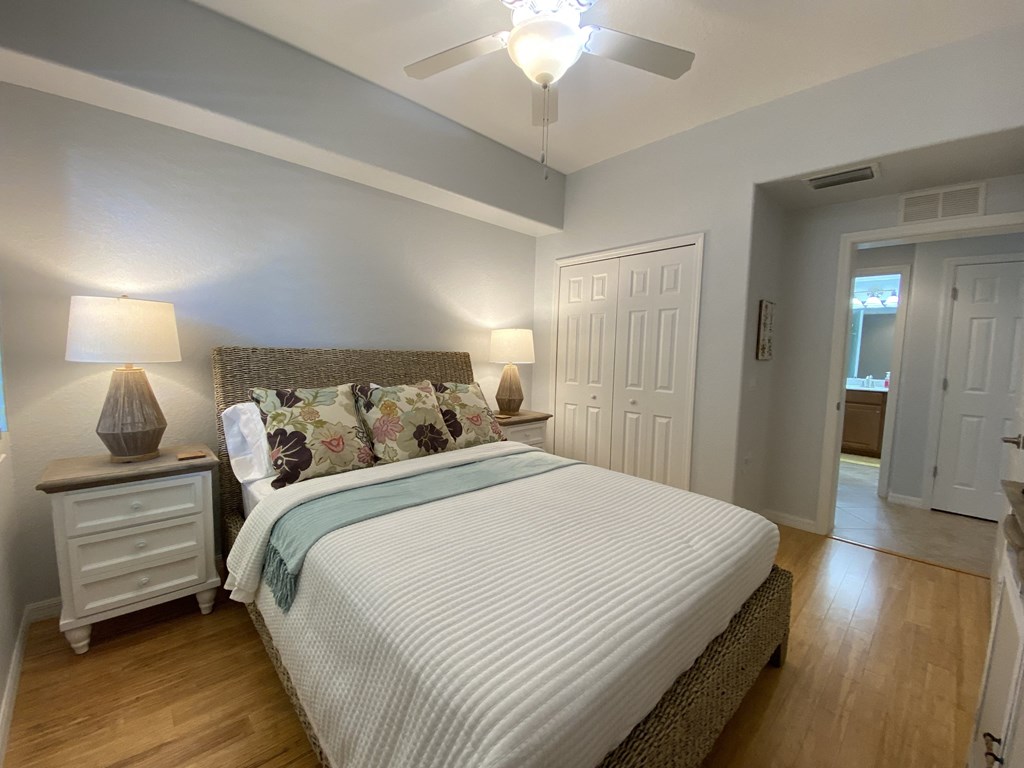 a bedroom with a large bed and a ceiling fan