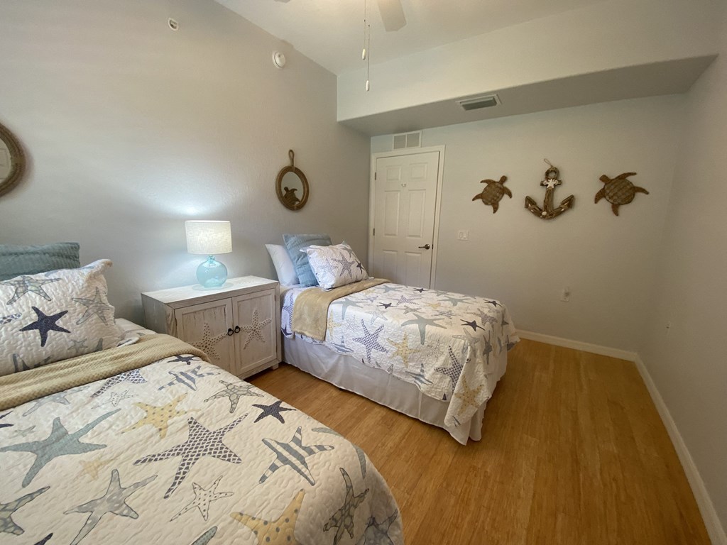 two twin beds in a bedroom with seashells on the wall