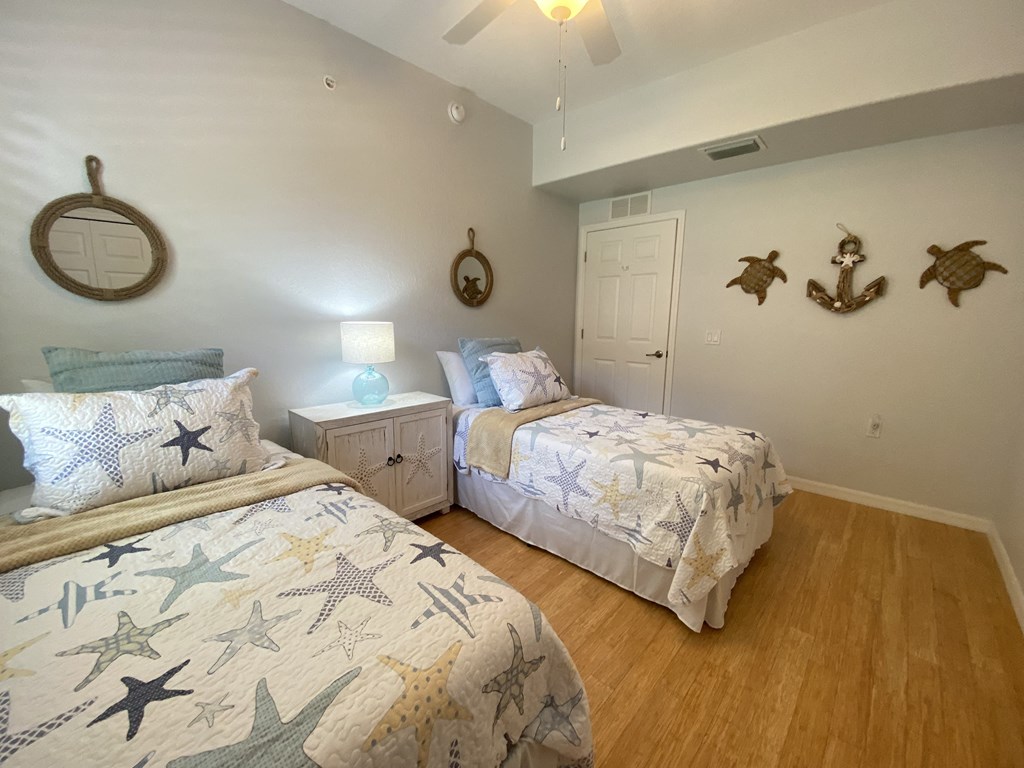 two twin beds in a bedroom with seashells on the wall