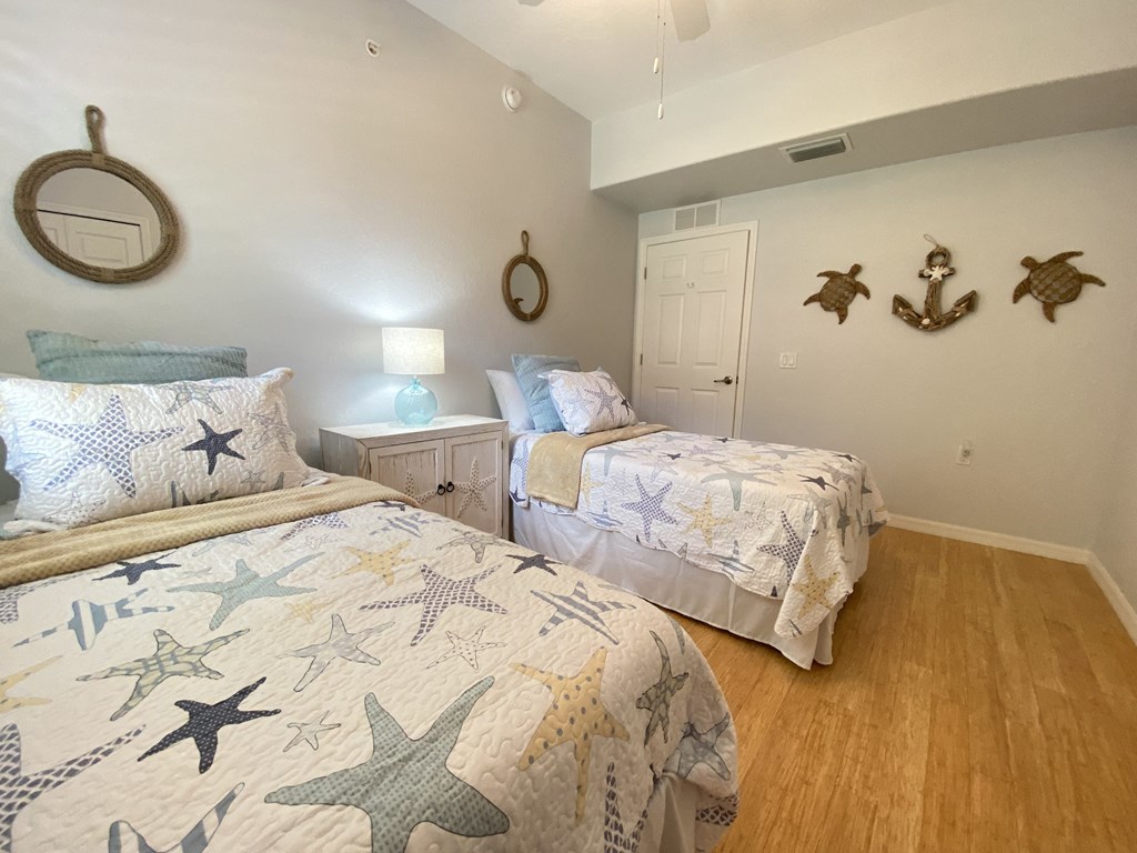 two twin beds in a bedroom with starfish on the wall