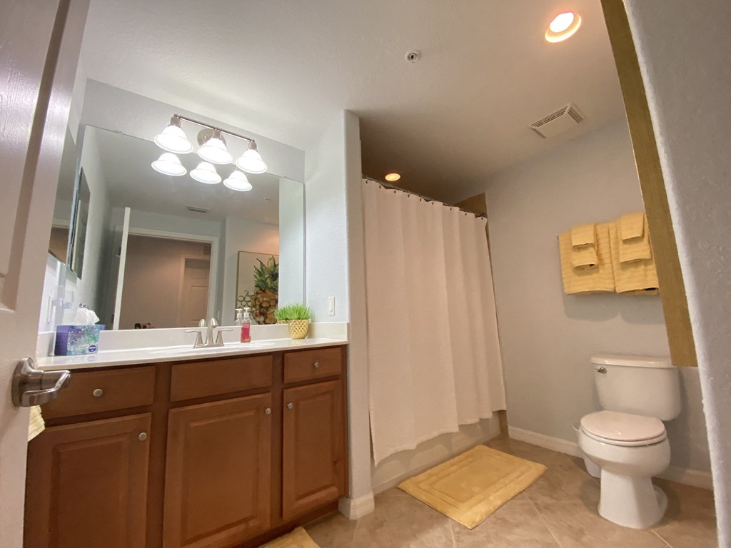 a bathroom with a toilet and a sink and a mirror