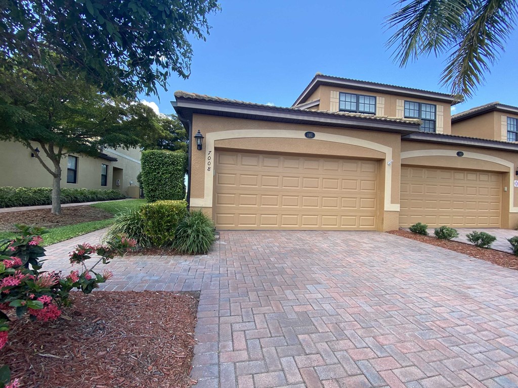 a garage door with a driveway in front of a house
