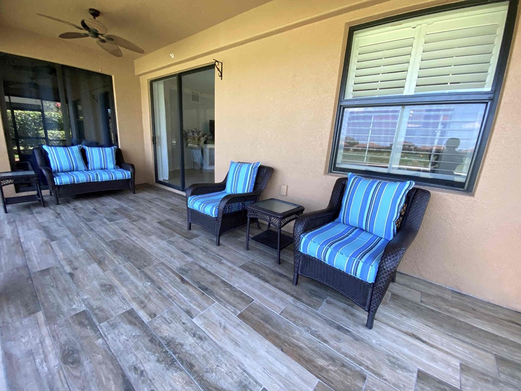 a patio with chairs and a sliding glass door