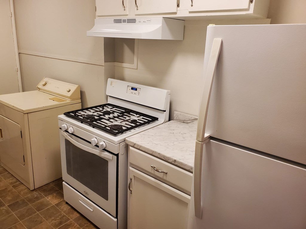 A white oven and refrigerator in a kitchen.