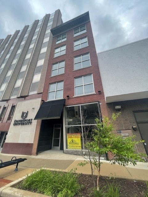 a tall building with a sign in front of it