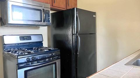 a kitchen with a stove and a refrigerator