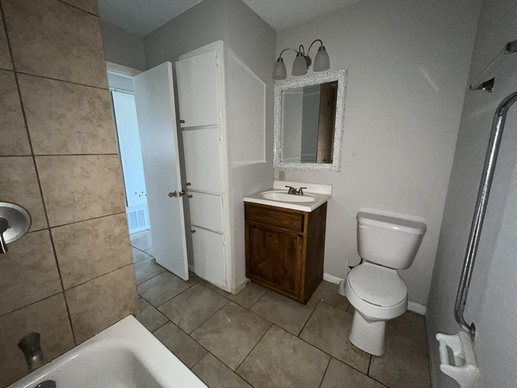 a bathroom with a toilet and a sink and a mirror