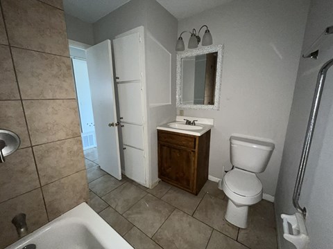 a bathroom with a toilet and a sink and a mirror