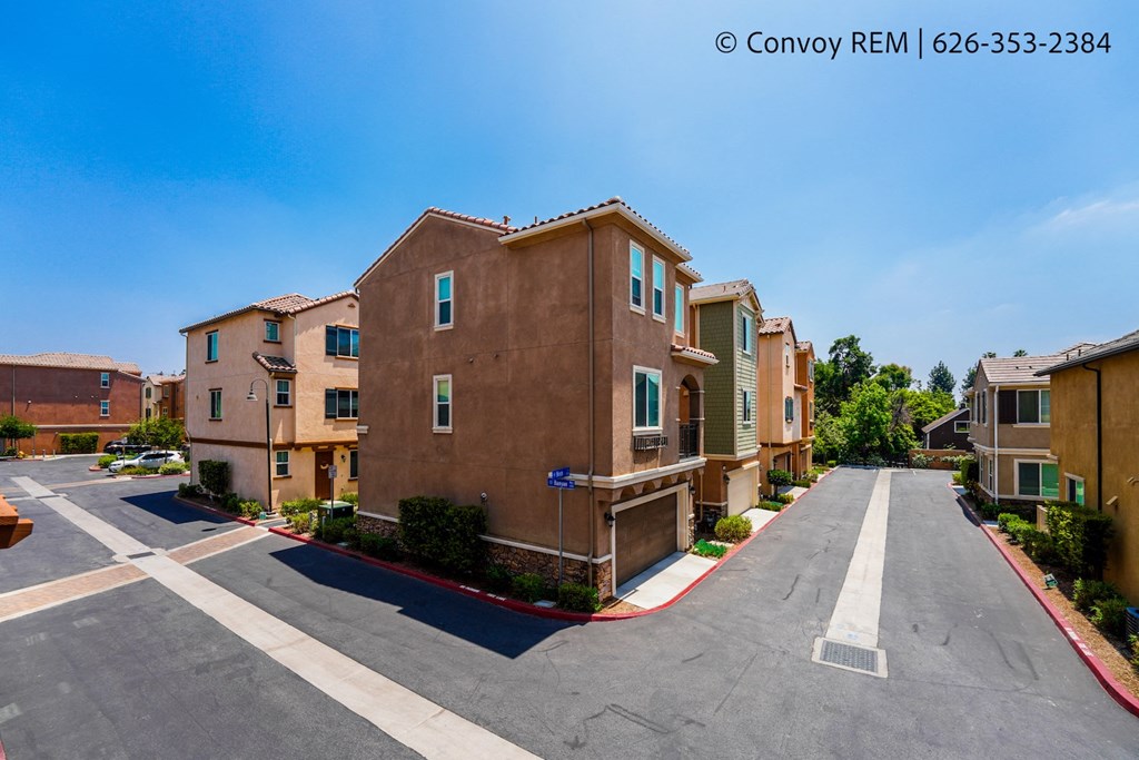 an empty parking lot in front of an apartment building