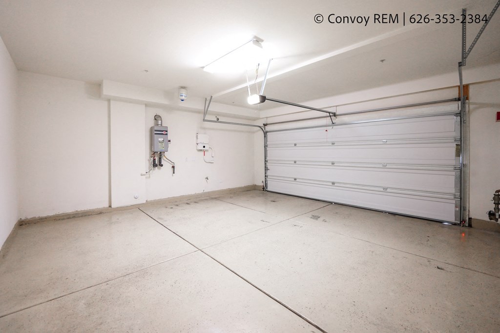 the interior of a garage with a white wall and a white garage door