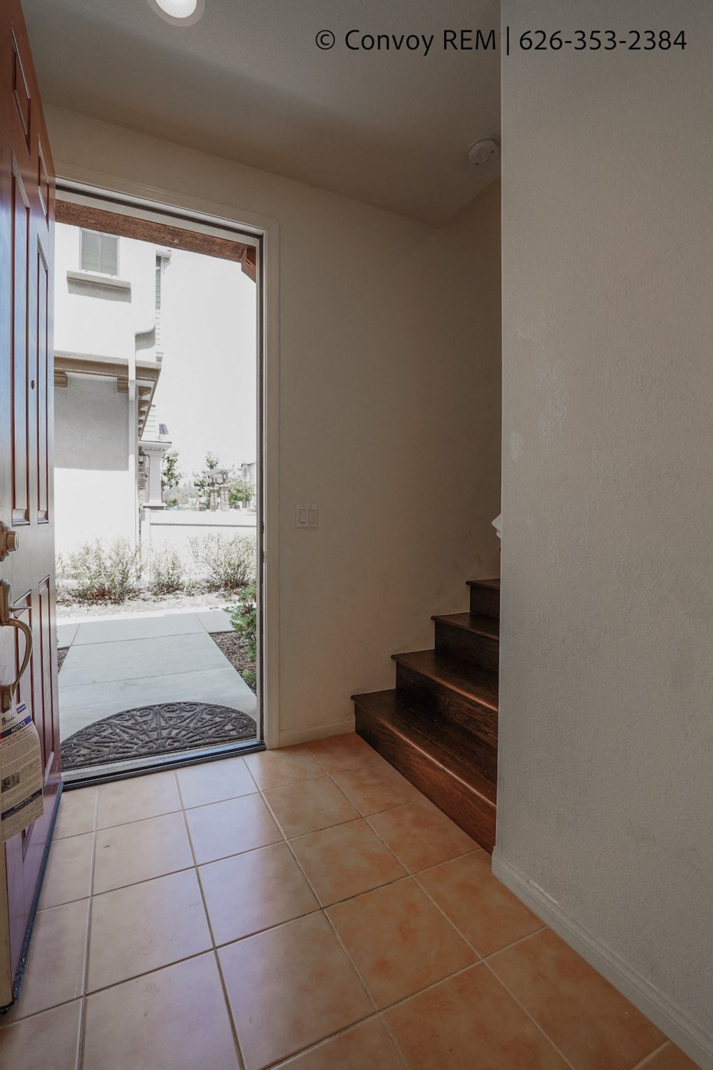 a view of the hallway from the front door of a house