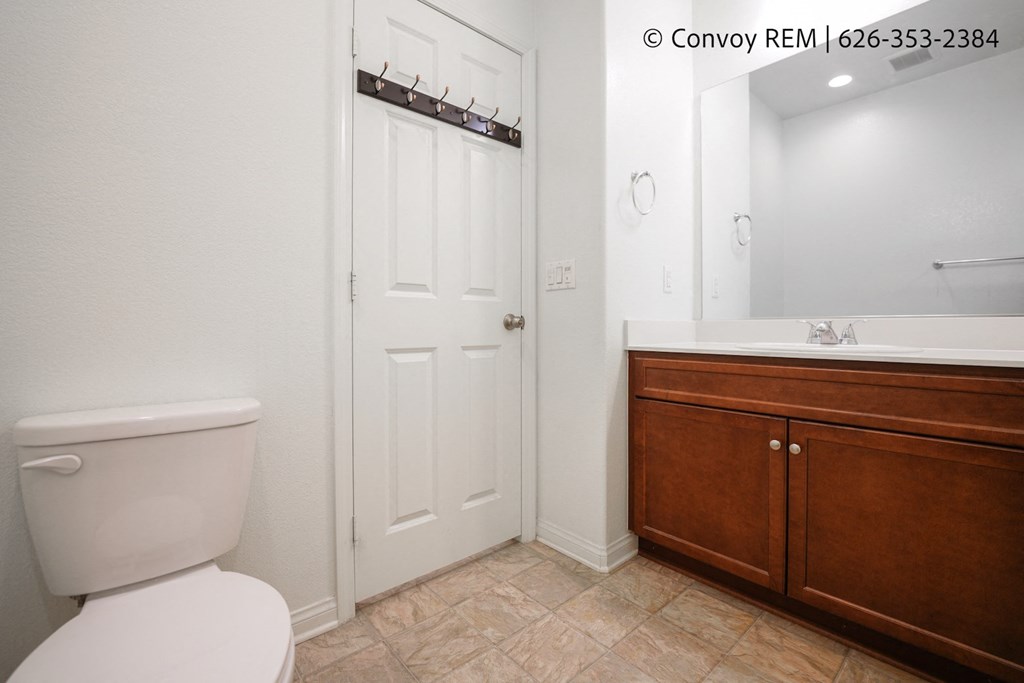 a bathroom with a toilet and a sink and a mirror