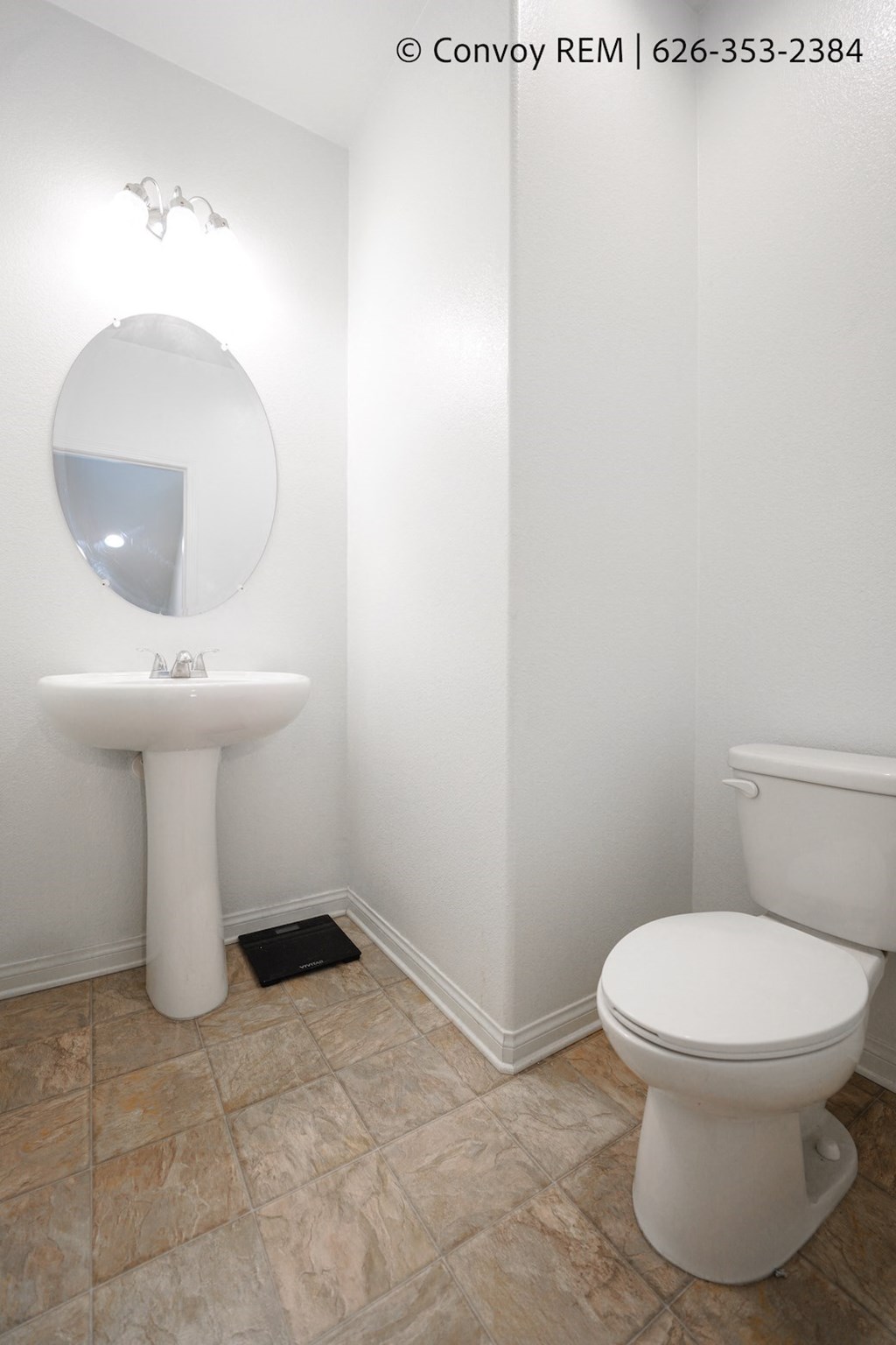 a bathroom with a toilet and a sink and a mirror