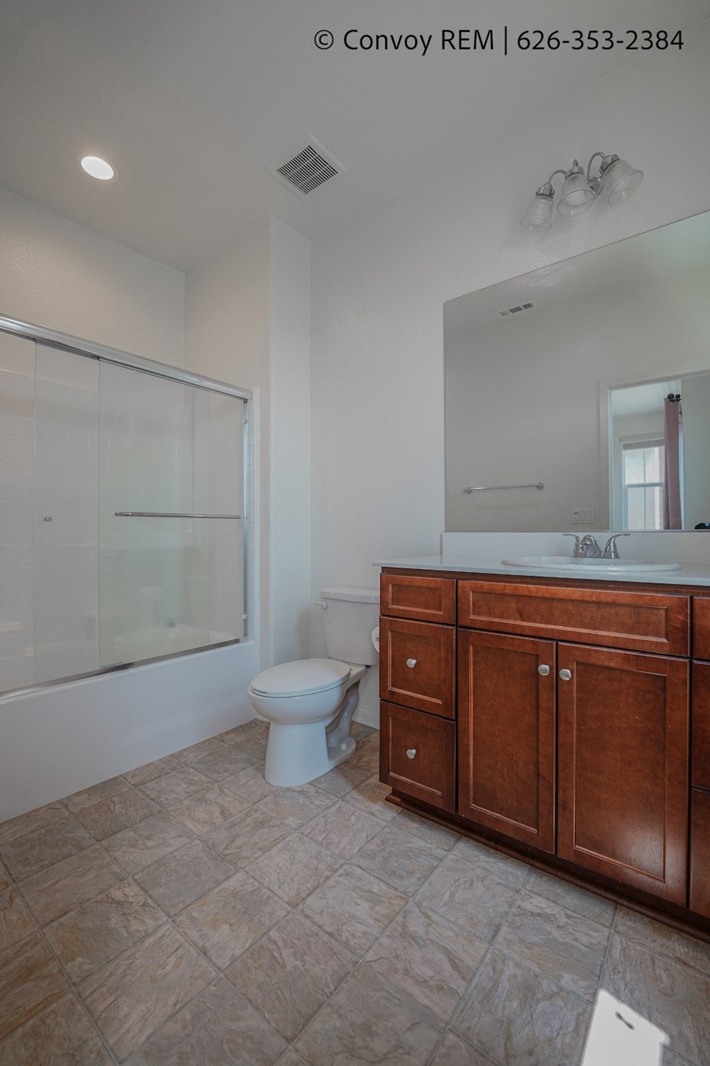 a bathroom with a toilet and a sink and a shower