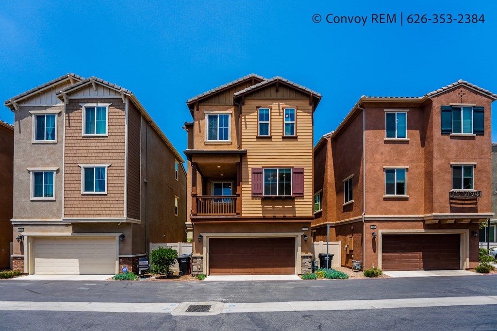 three story brick apartment buildings with garages on the street
