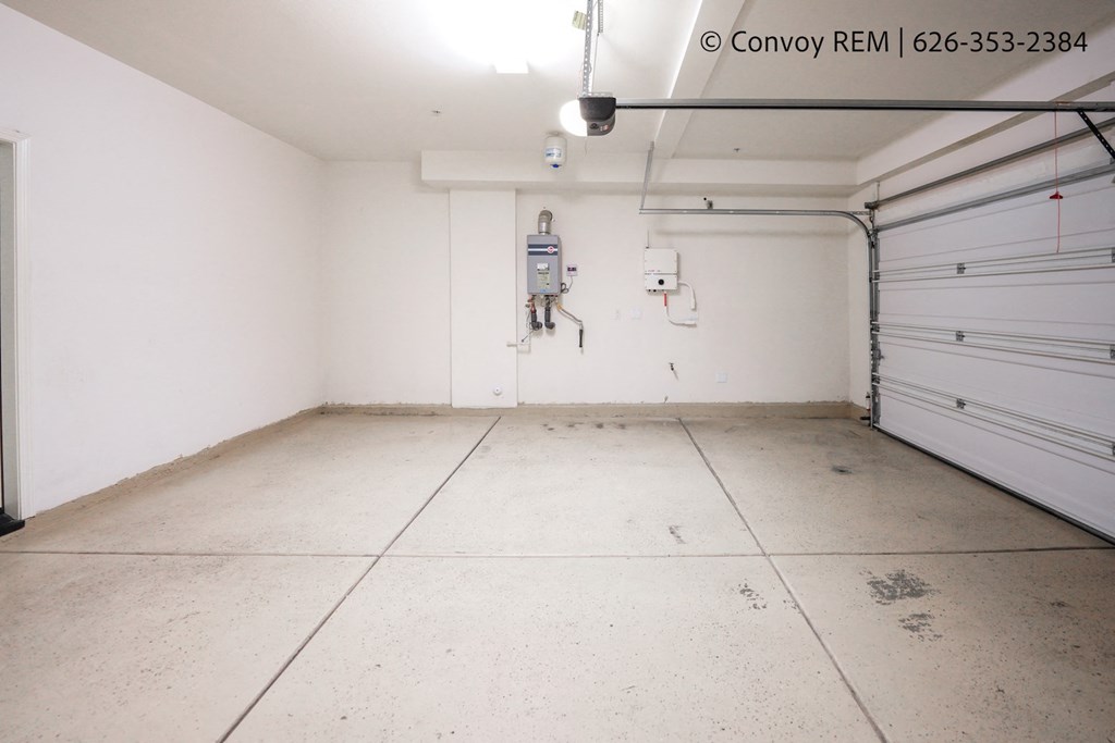 the interior of a garage with white walls and doors