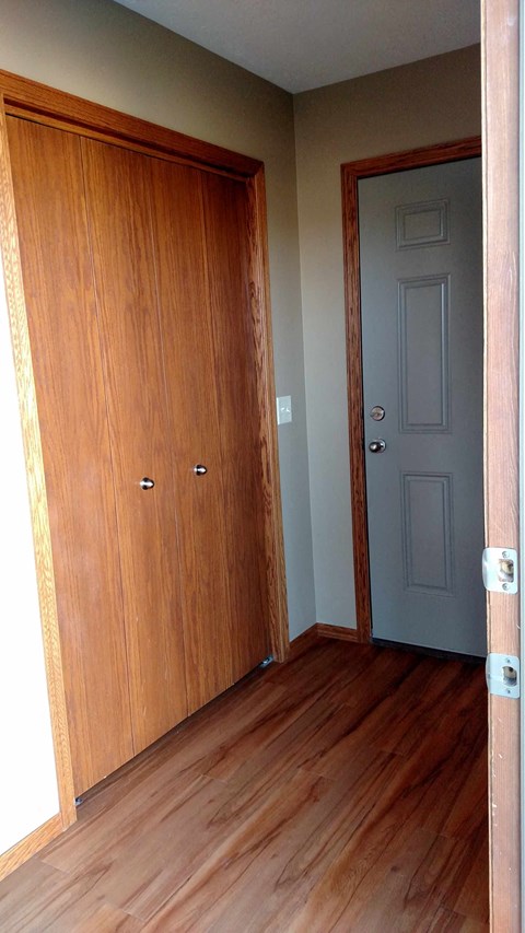 A brown door is on the left and a grey door is on the right.