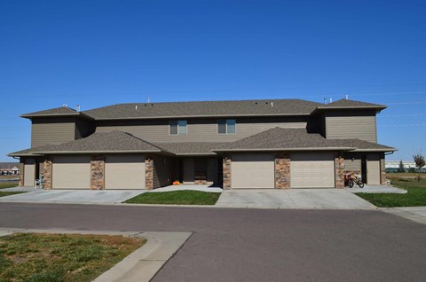 A house with a brown roof and garage doors.