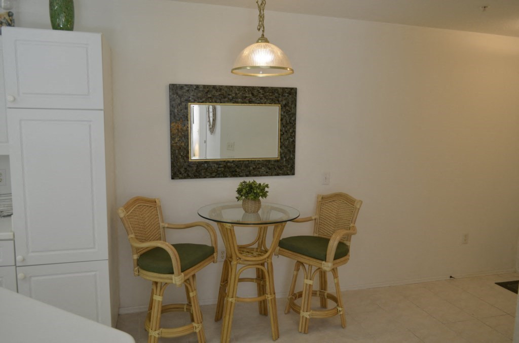 a dining area with a table and chairs in a kitchen