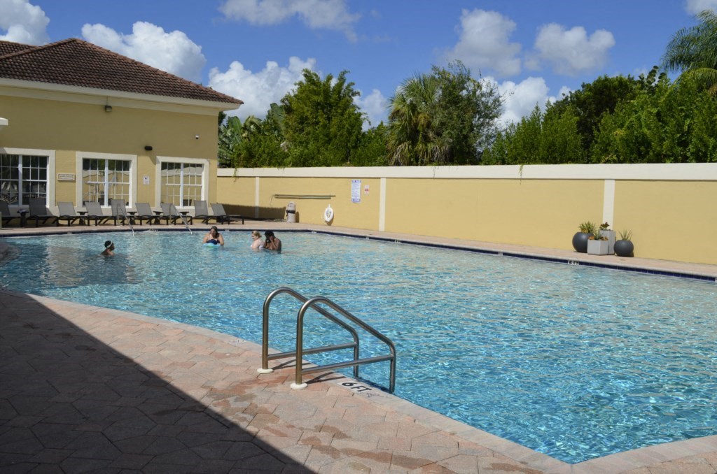 a swimming pool with people in it in front of a building