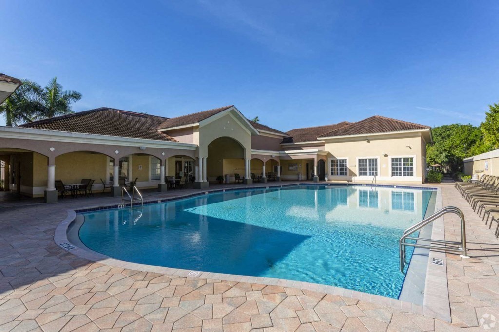 a large swimming pool in front of a house