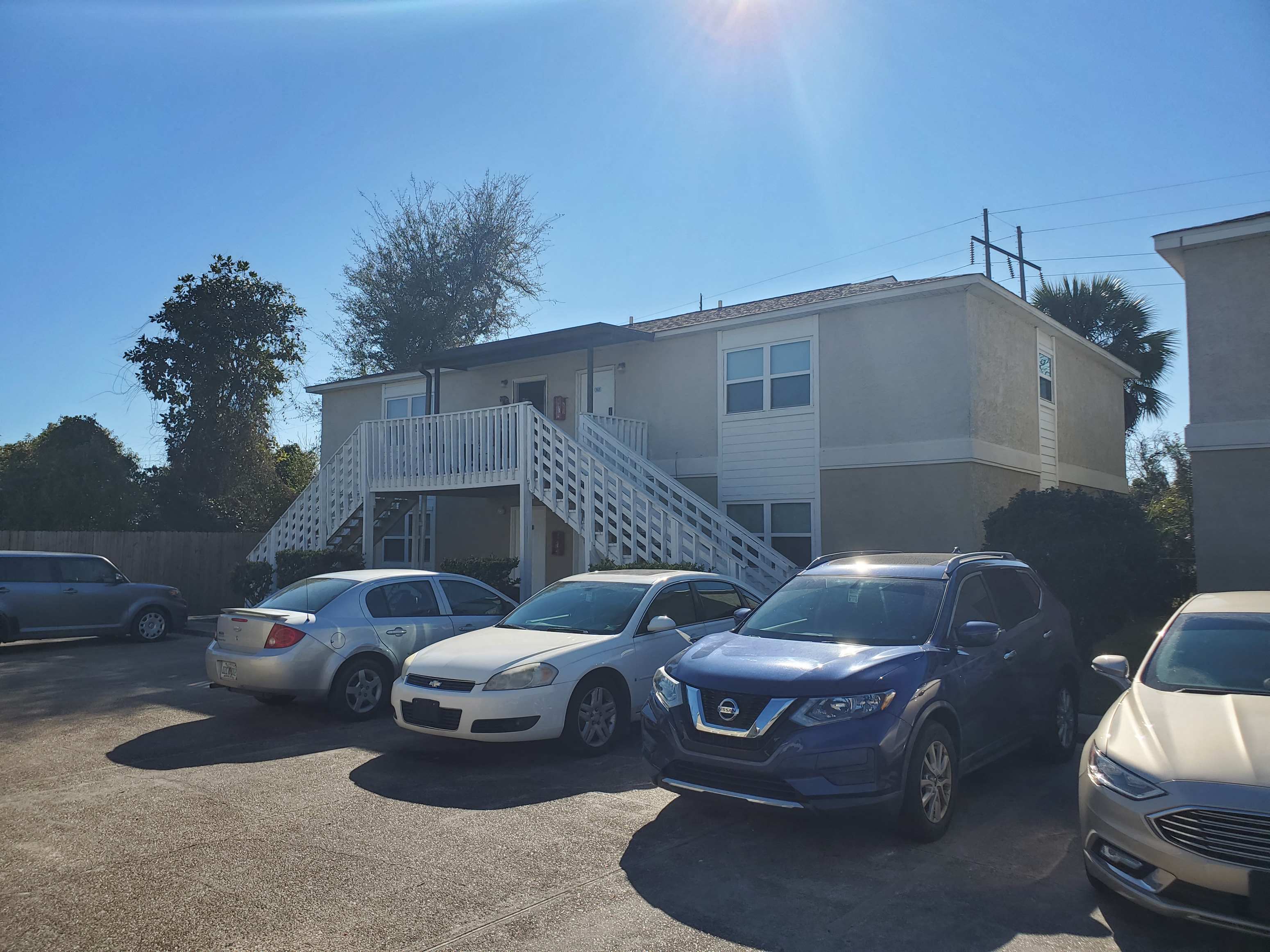 a parking lot with cars in front of a building