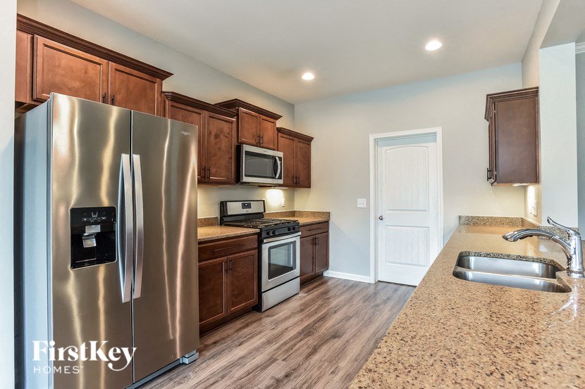 a kitchen with stainless steel appliances and wooden cabinets