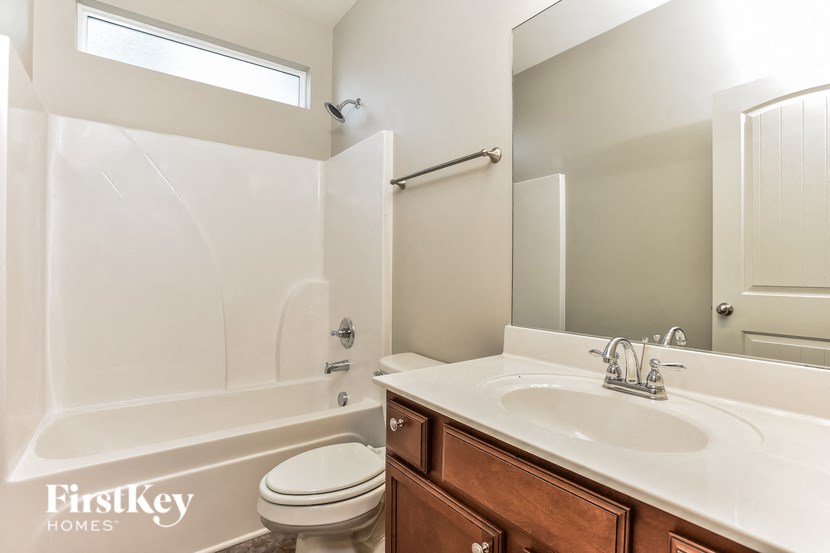 a bathroom with a sink toilet and a bath tub