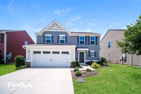 A house with a red garage door is for sale.