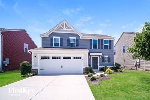A two-story house with a garage is for sale.