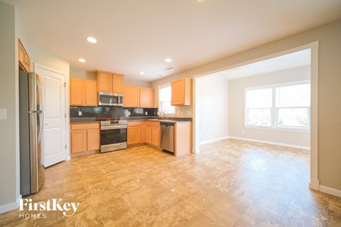 A kitchen with wooden cabinets and a refrigerator.