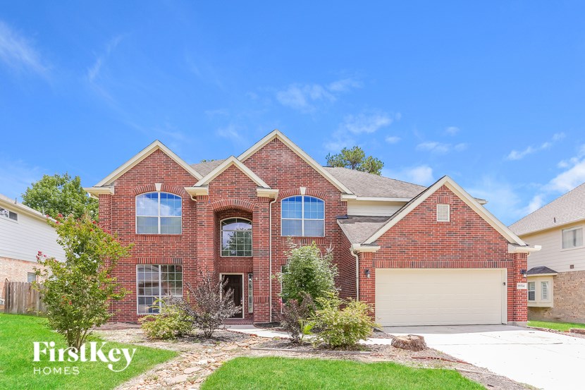 A brick house with a garage door and a driveway.