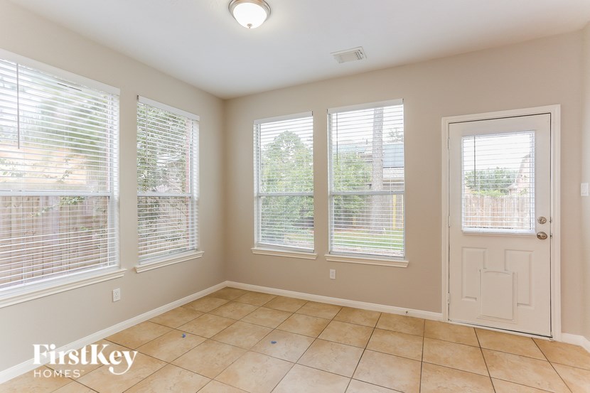 A room with a tiled floor and a door on the right side.