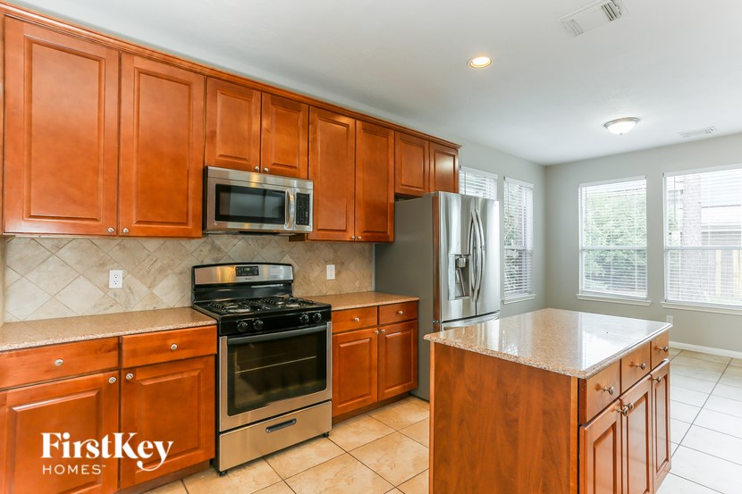 A kitchen with wooden cabinets and stainless steel appliances.