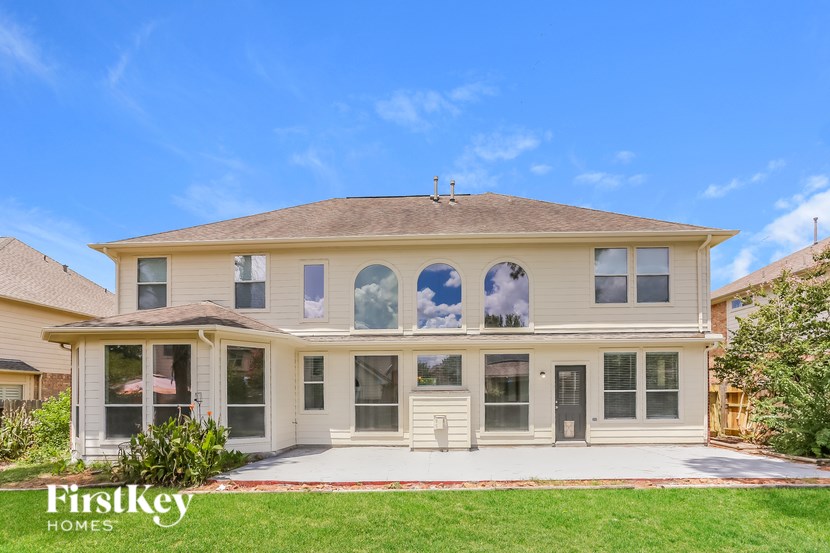 A house with a clear blue sky above it.