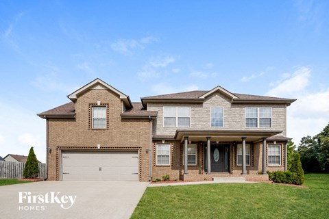 a large brick house with a white garage door