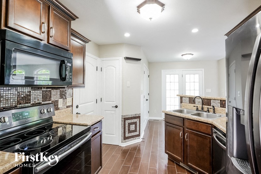 a kitchen with a stove microwave and a sink