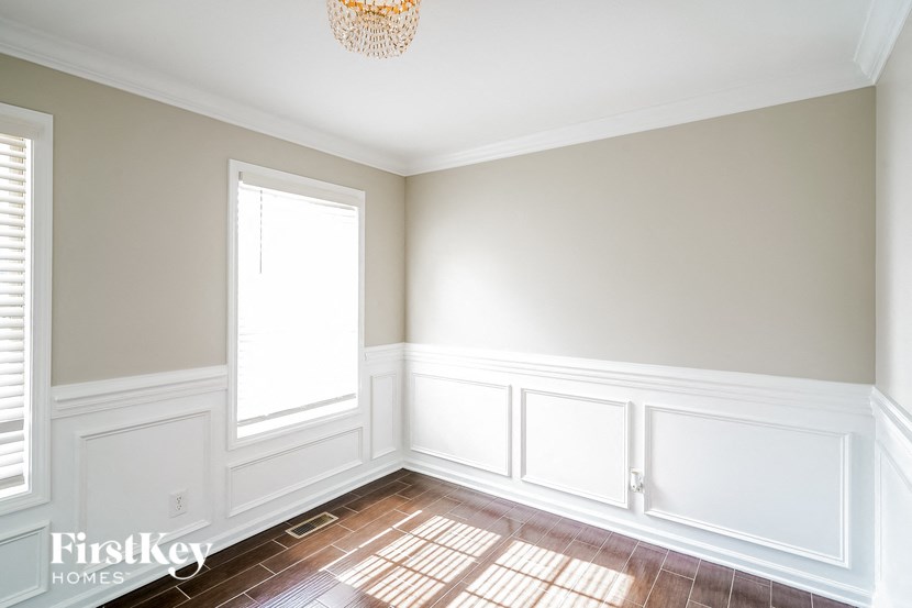 a empty room with white walls and a chandelier