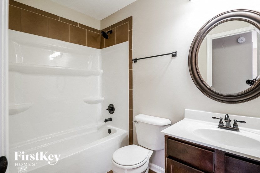a bathroom with a sink toilet and a bath tub