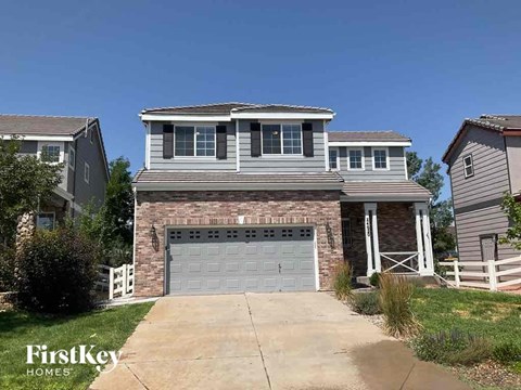 a brick house with a garage door in front of it