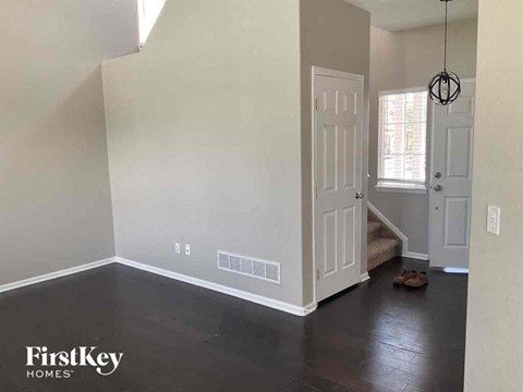 an empty room with white walls and a white door