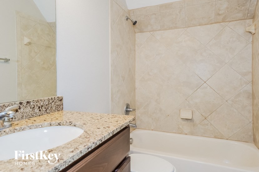 a bathroom with a sink and a tub and a shower