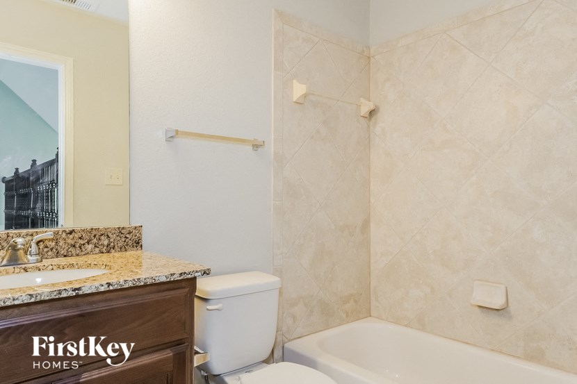 a bathroom with a toilet and a sink and a bath tub